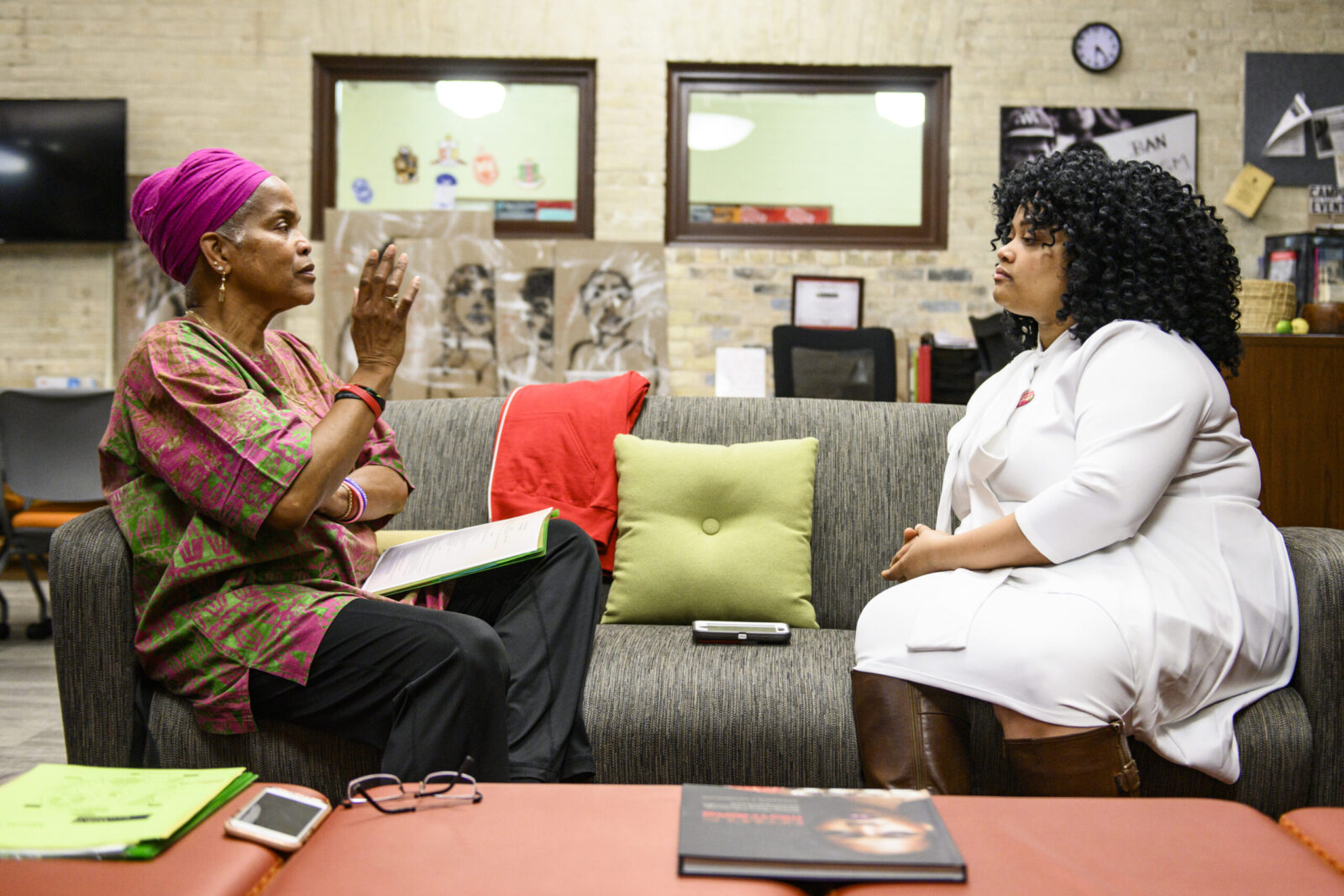 Student interviewing Hazel while sitting on a couch facing each other.